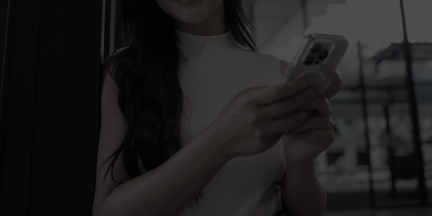 Person using a smartphone in a modern setting.