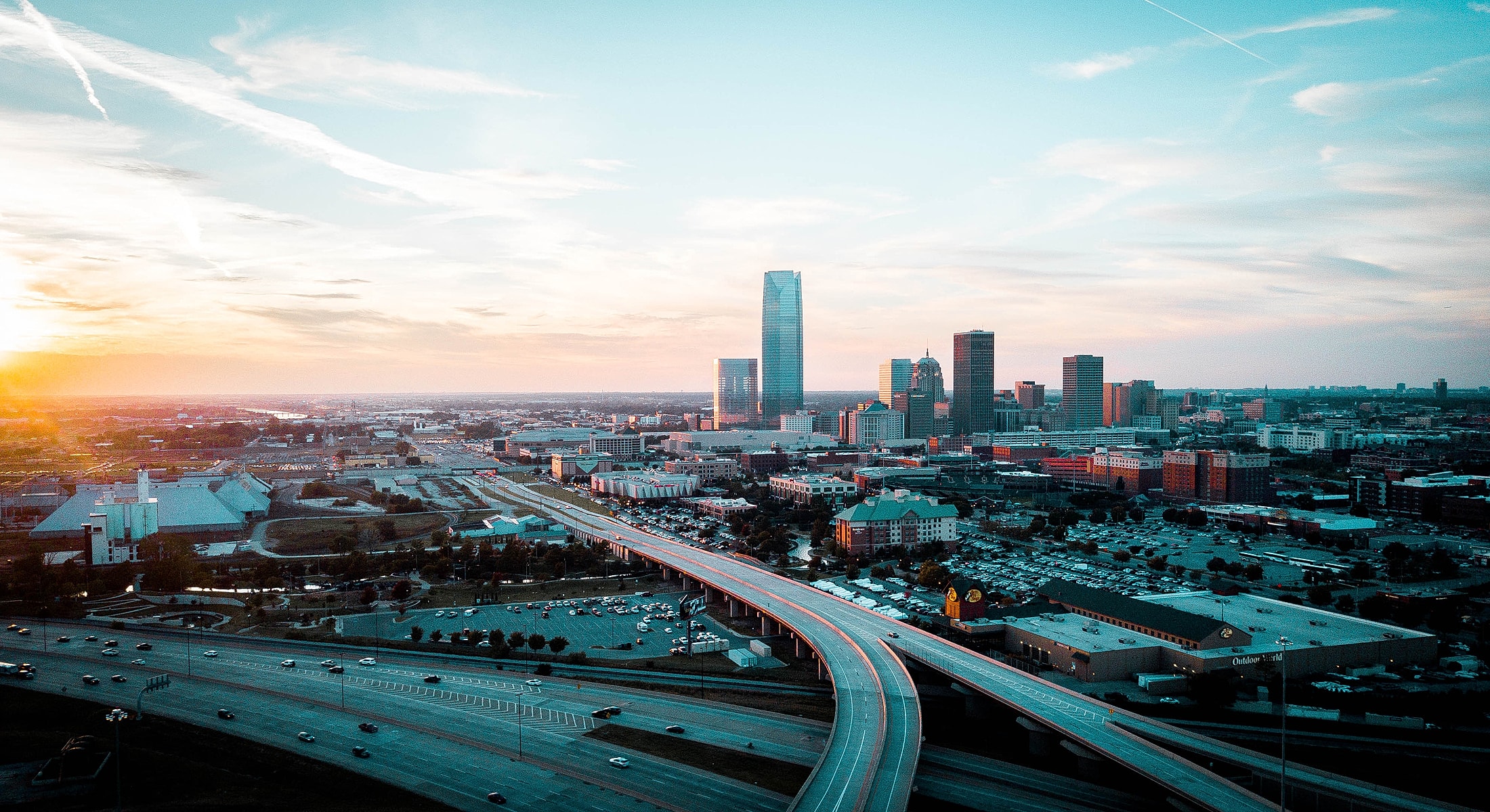 Aerial view of city skyline at sunset.