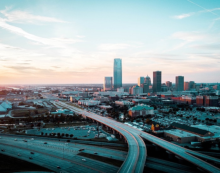 Oklahoma City skyline at sunset with highways.