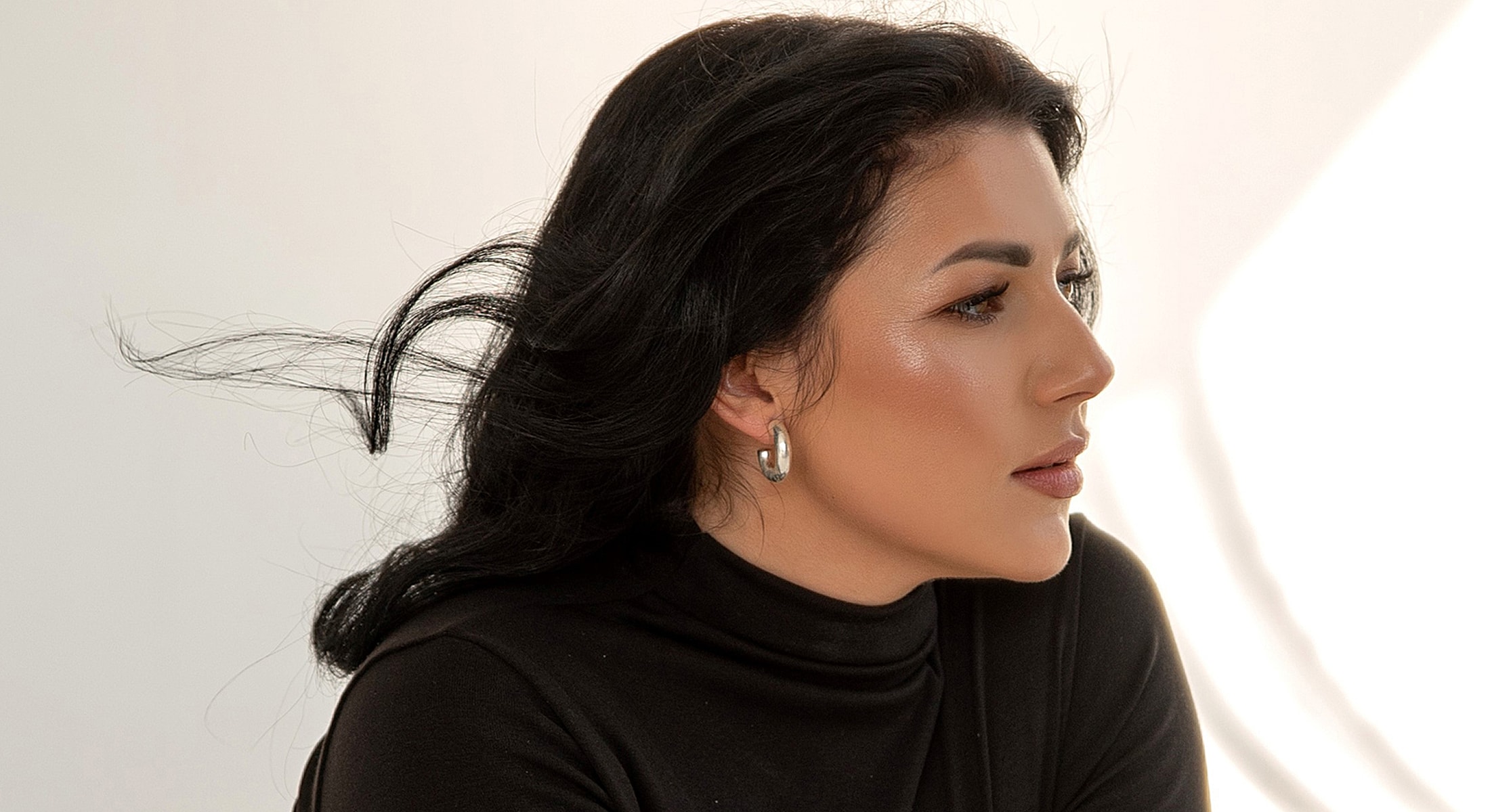 Profile of a woman with flowing hair.