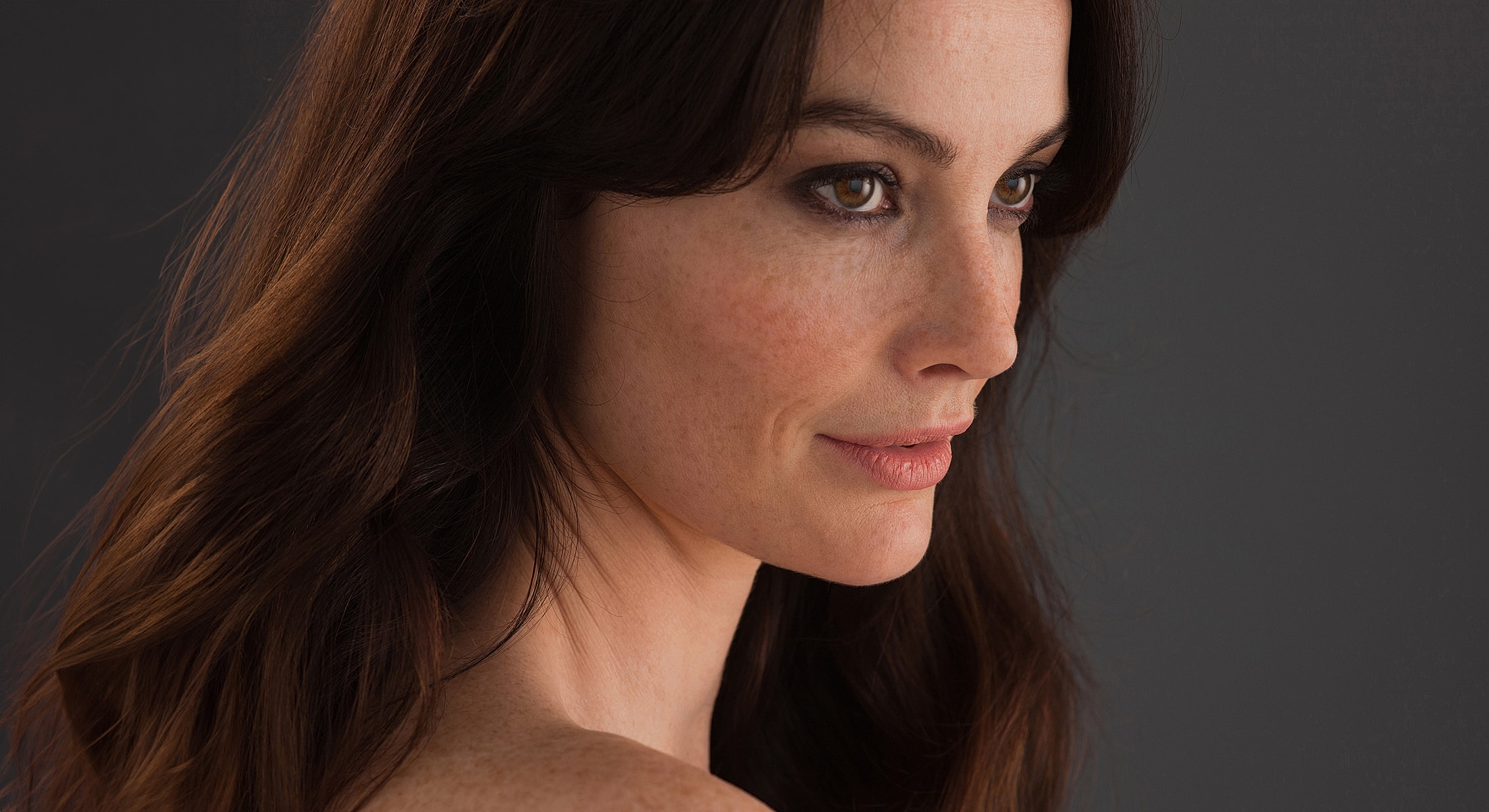 Profile of a woman with long brown hair.