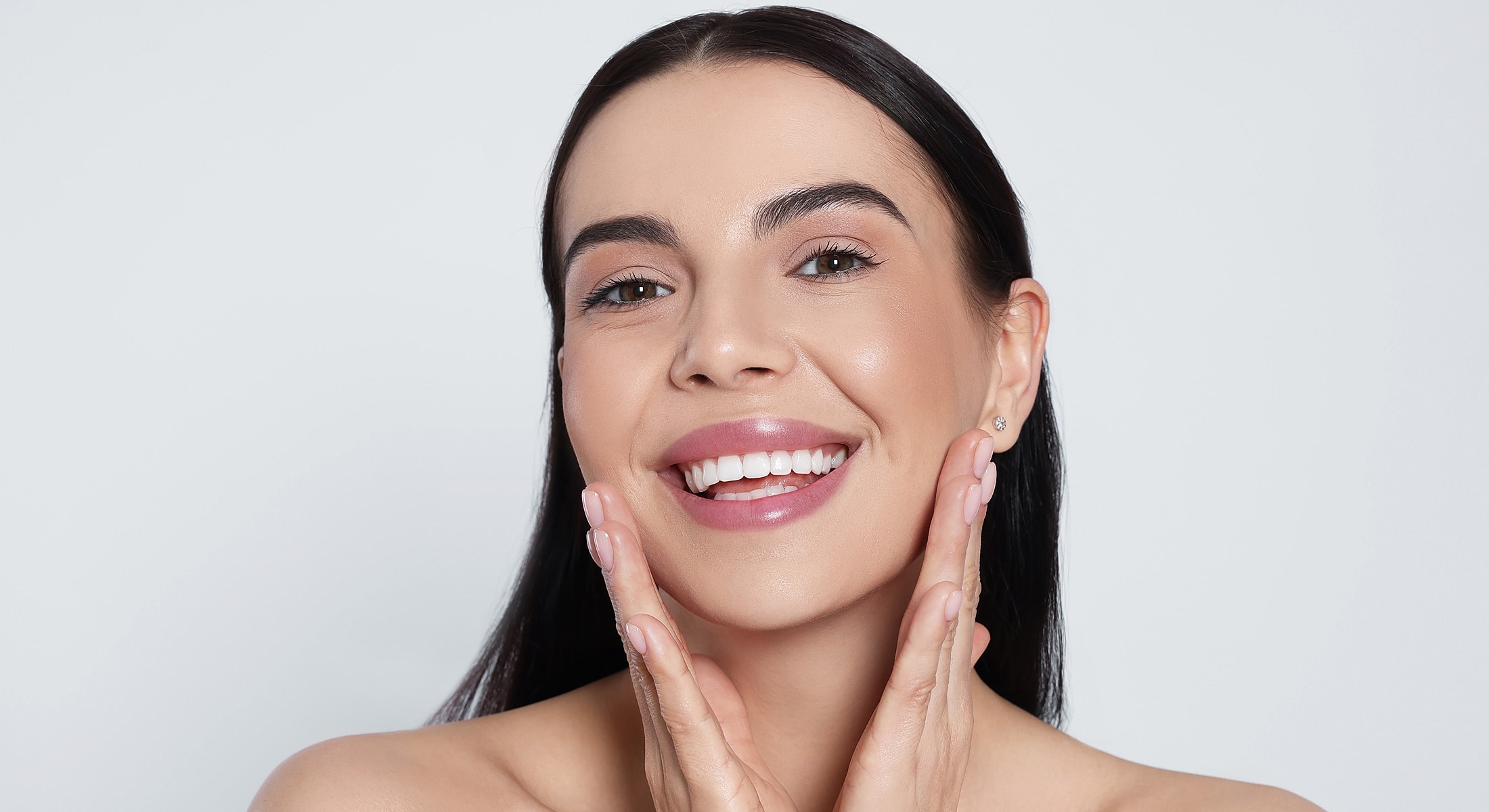 Smiling person with healthy skin and radiant glow.