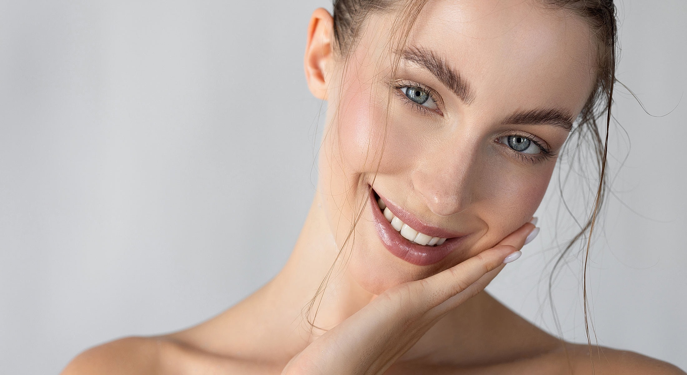 Smiling woman with beautiful skin and soft expression.